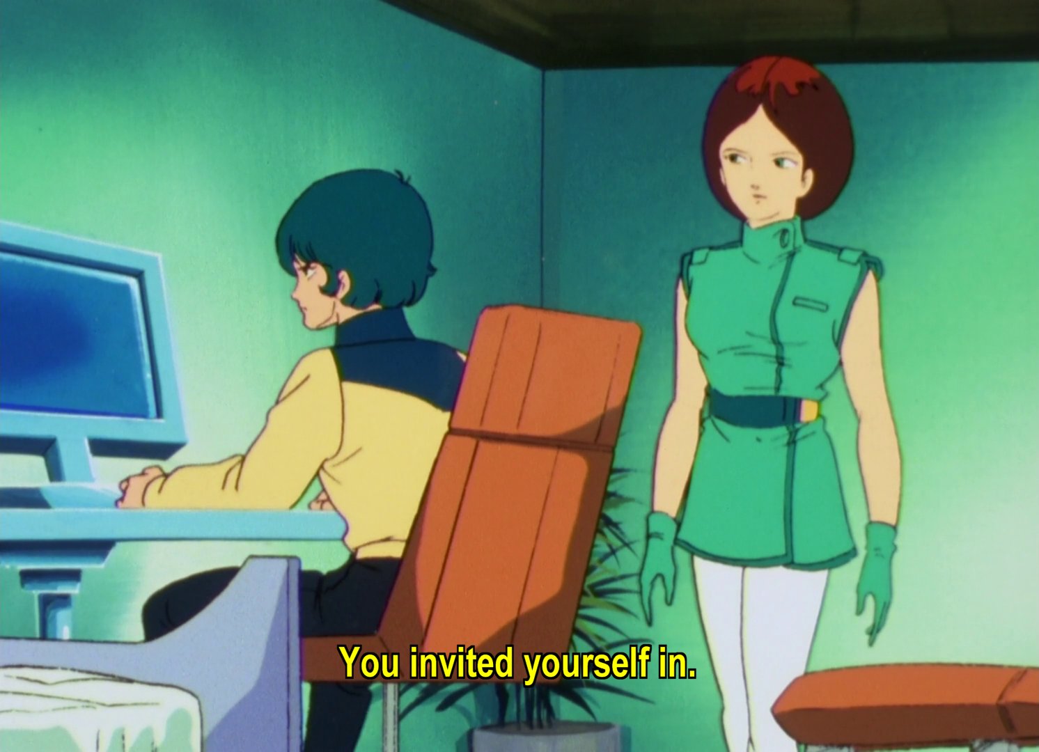 Kamille angry at a desk, with Emma, a woman with chin length brown hair.  Kamille: You invited yourself in.