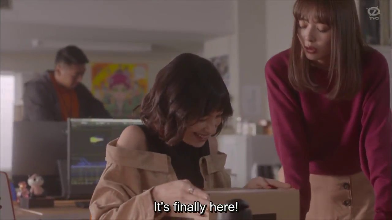 Momoe and Ume, a woman with short wavy hair, with a box.  Ume: It's finally here!