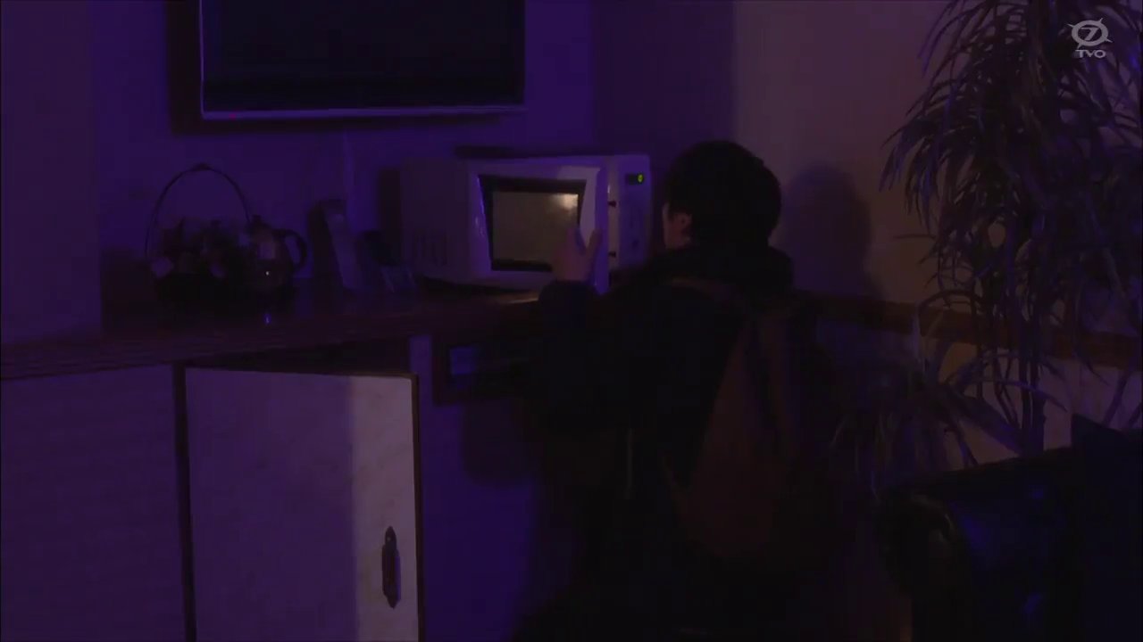 Teenager, looking inside a microwave