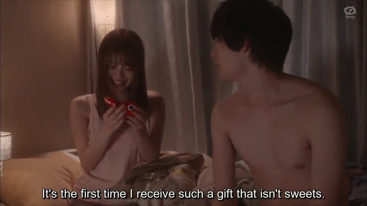 Momoe, sitting in bed with Matsuda, holding a tin toy: It's the first time I receive such a gift that isn't sweets.