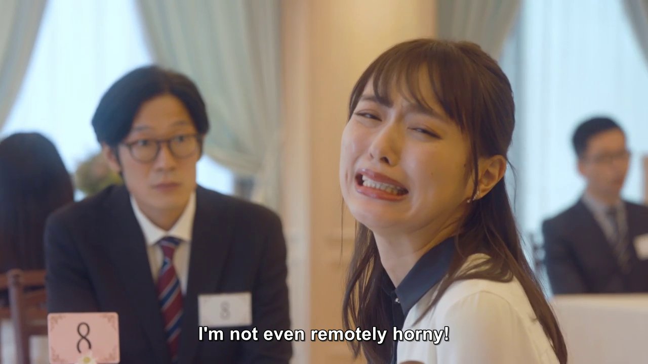Momoe, looking away from her speed date, a man in a suit and glasses, distressed: I'm not even remotely horny!