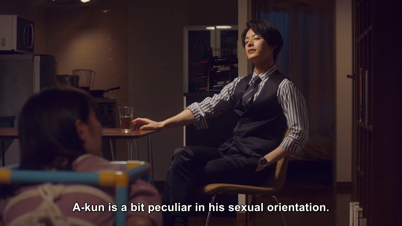 A-kun, sitting at a table.  Narrator: A-kun is a bit peculiar in his sexual orientation