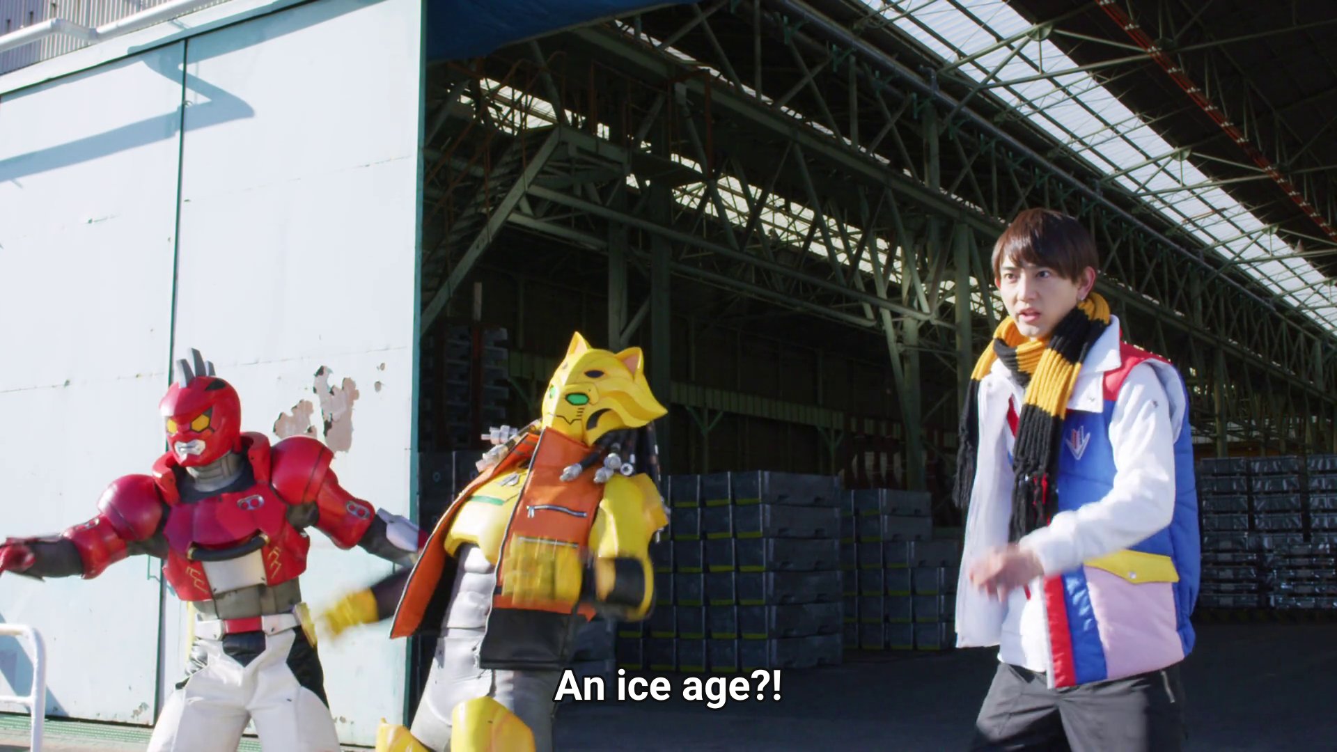 Kaito, wearing a scarf, with Gaon and Zyuran leaning like they're sliding beside him.  Subtitles: An ice age?!
