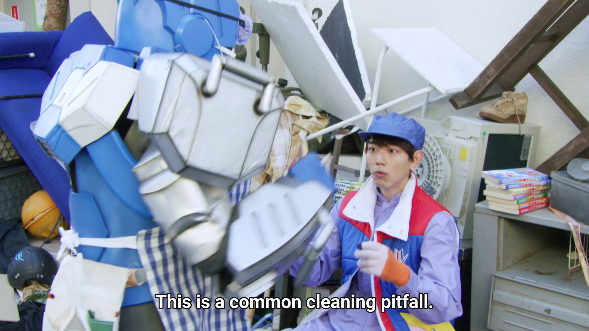 Kaito sitting surrounded by rubbish, getting scolded by Vroon: This is a common cleaning pitfall.